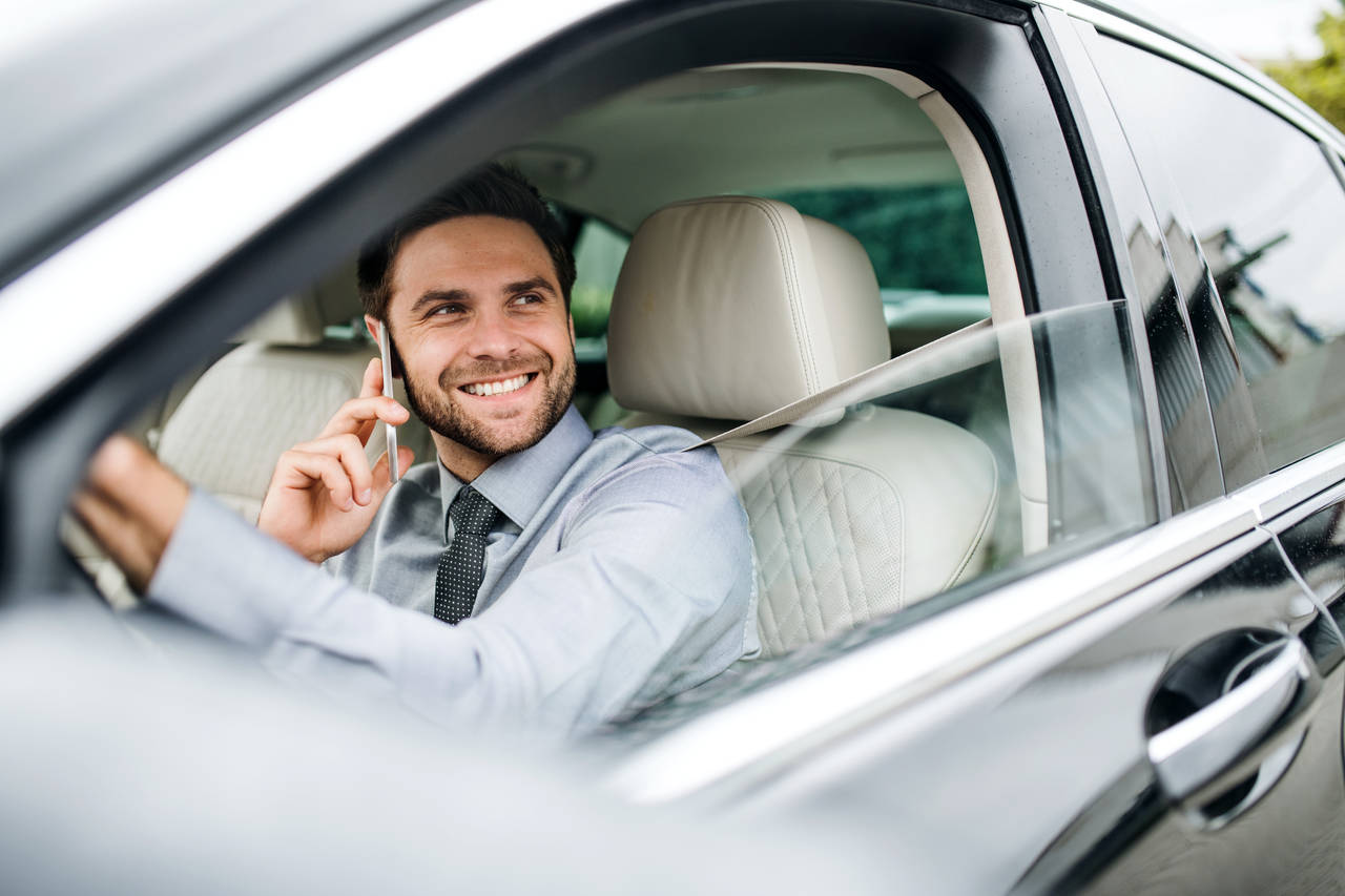 Photo of a man on the phone while driving